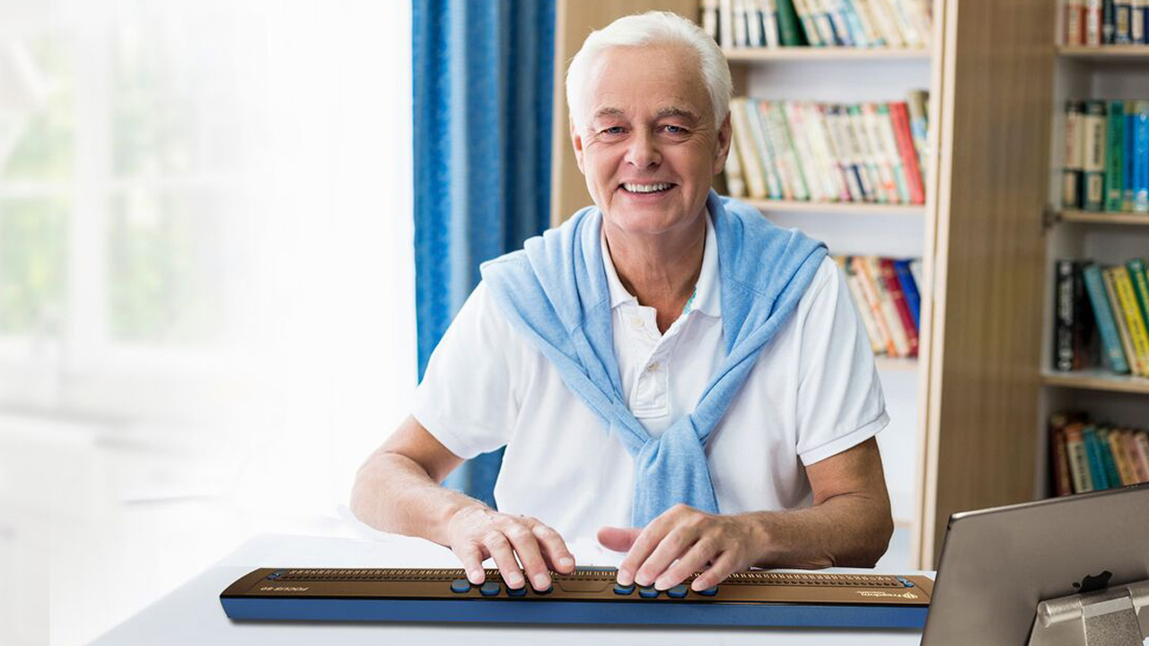 man using one of the Focus braille displays