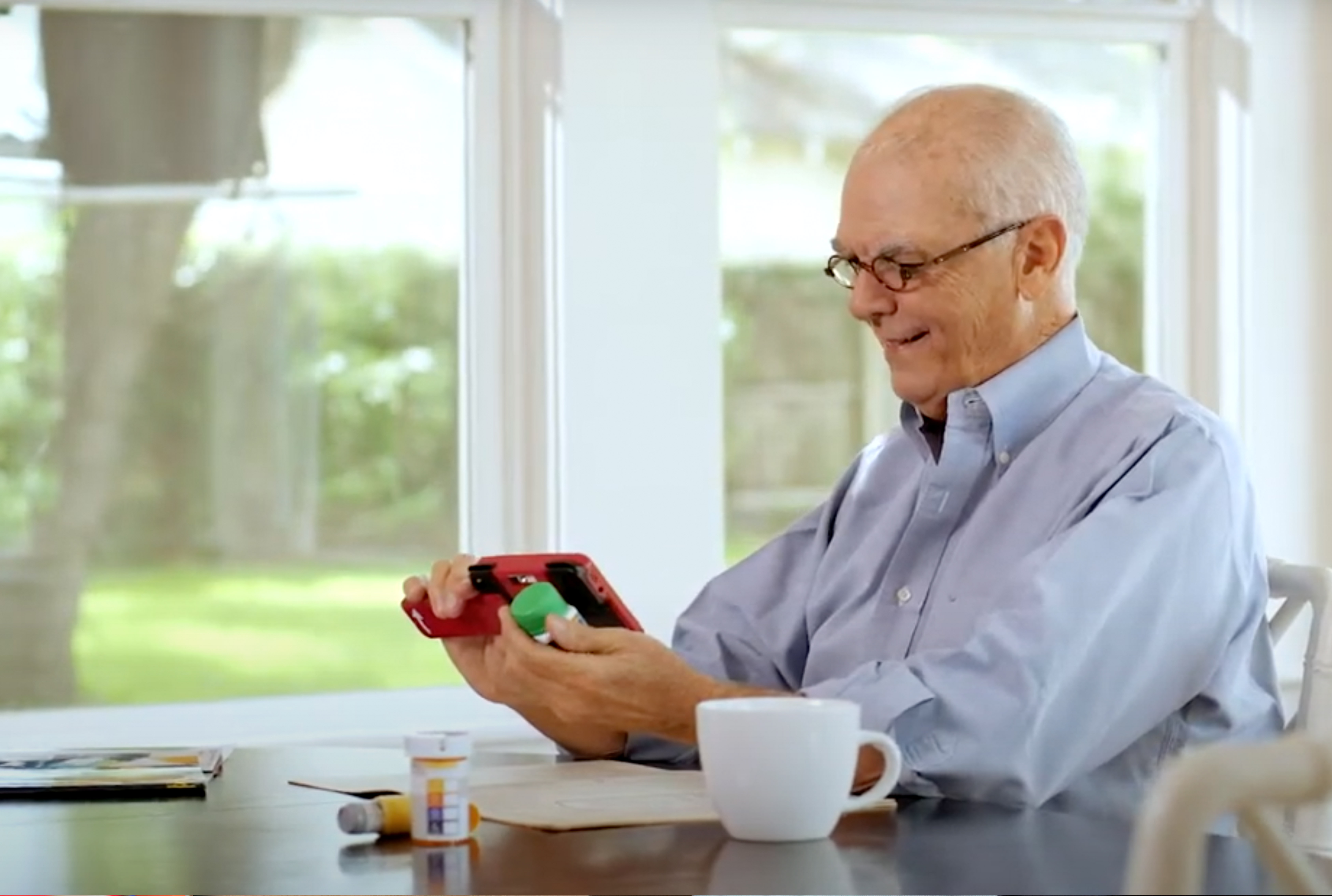 man using RUBY XL HD to read medication at home